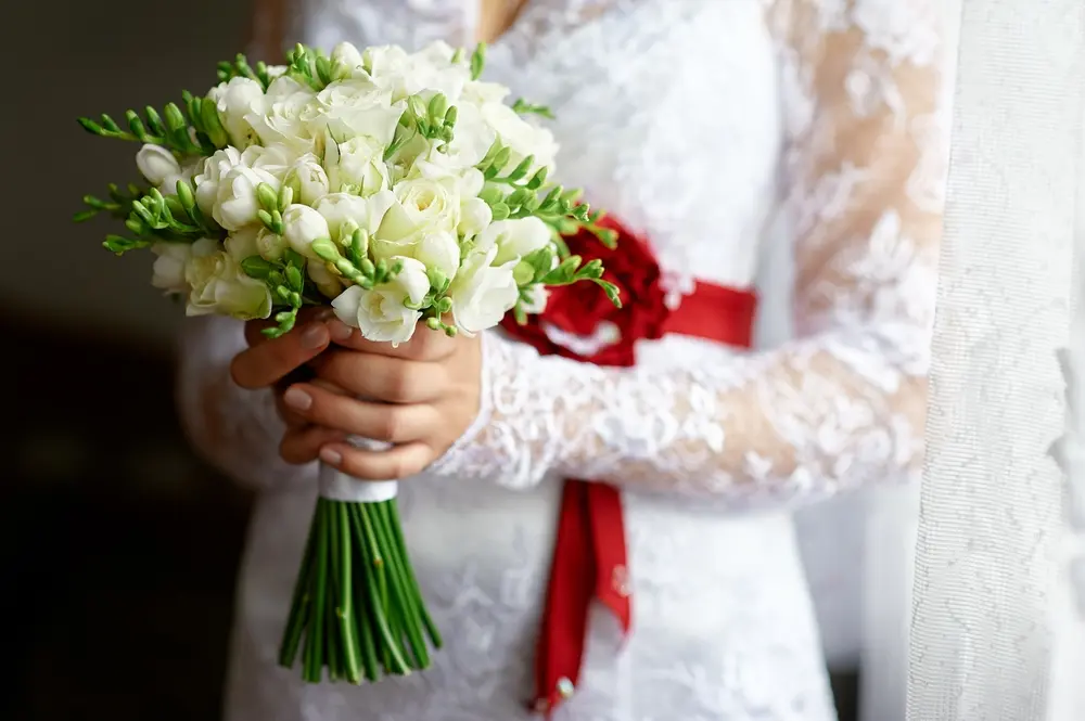 Bride holding a white wedding flower bouquet for a Brentwood, PA wedding florist